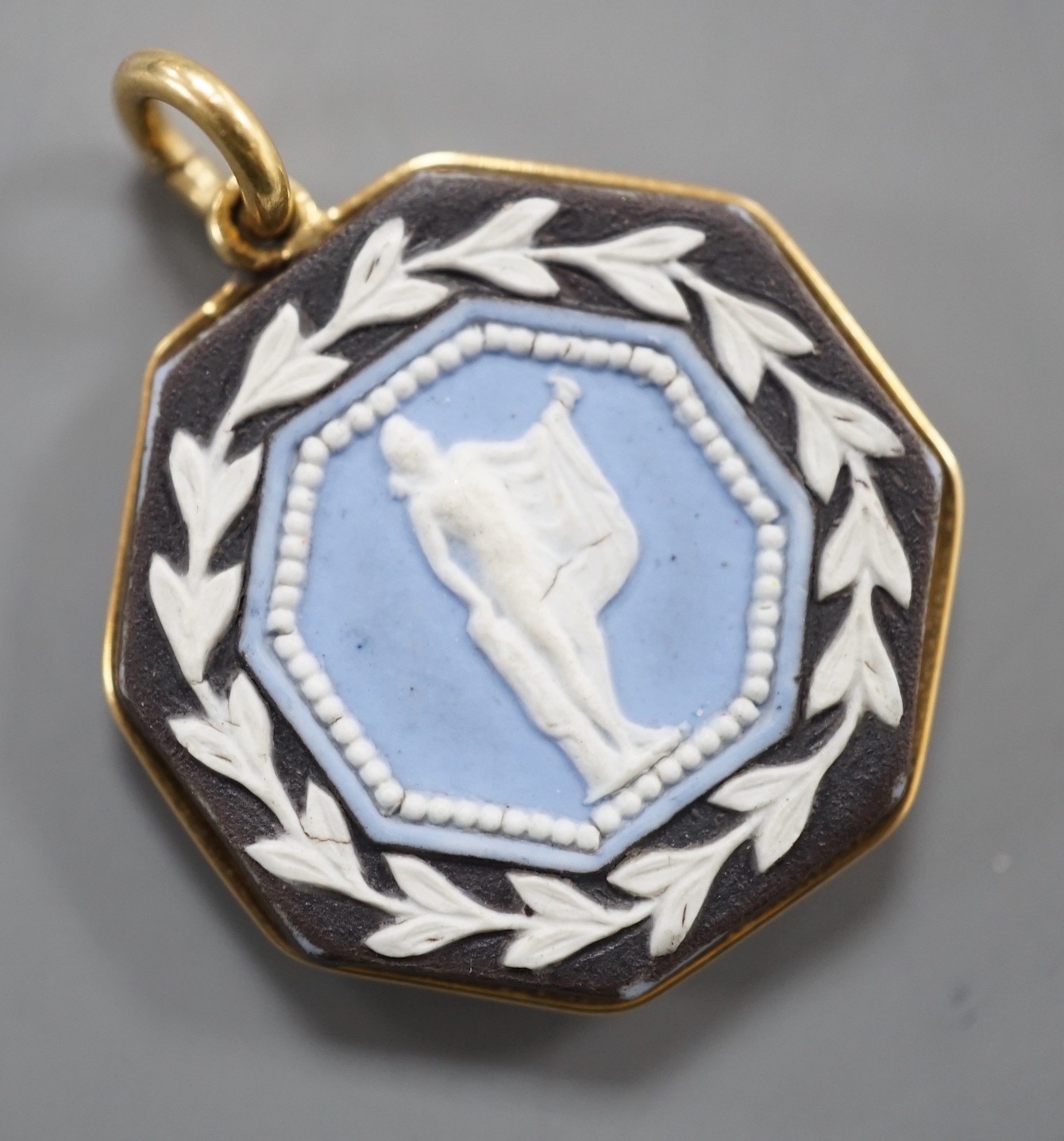 A late 19th/early 20th century yellow metal and two colour Wedgwood double sided octagonal pendant, 21mm.